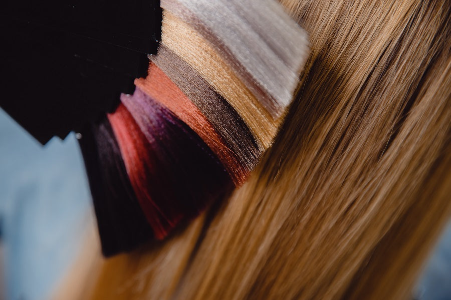 Hair extension color palette next to blonde hair
